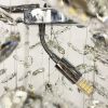 Видовжена срібна люстра DIAMINA з кришталевим камінням 120 см